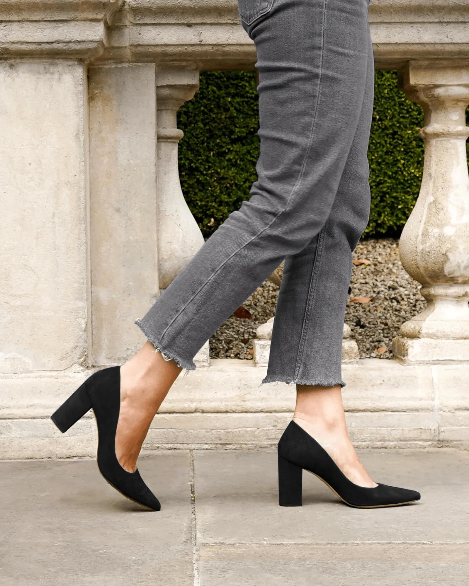 Model walking in black suede block heels image