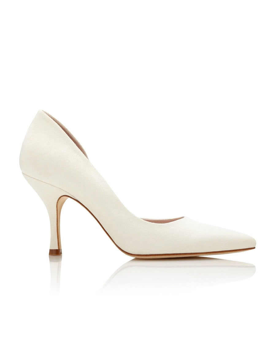 White pointed-toe heels with a slender stiletto heel, approximately 3 inches high. The shoes are made of a smooth material and are displayed against a clean, white background, showcasing their elegant design. The image captures the shoes from a side angle, emphasizing the sleek silhouette. image