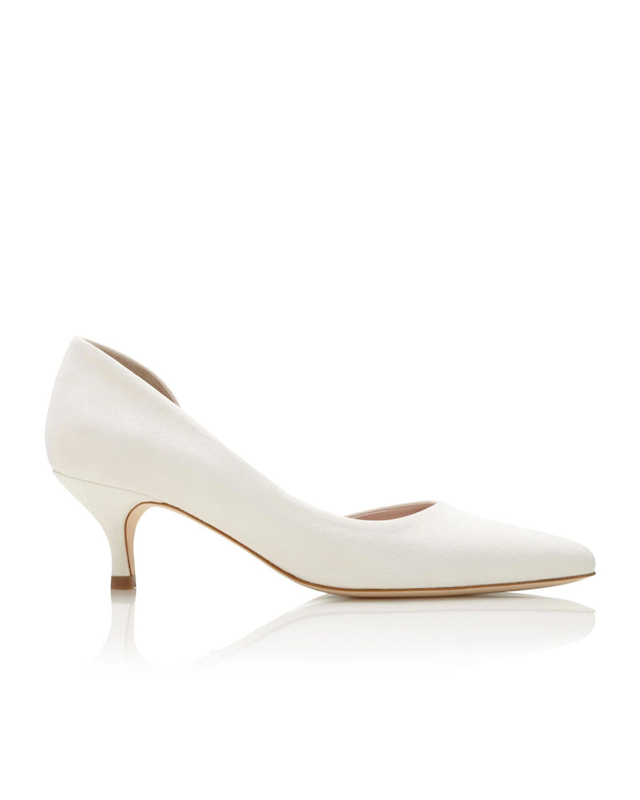 White leather heels with a pointed toe and a kitten heel, set against a clean, white background. The shoe is displayed at a slight angle, showcasing its elegant silhouette. image