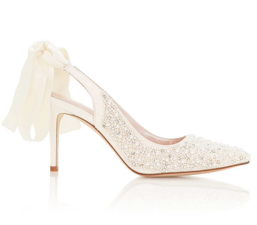 Elegant white slingback heels adorned with intricate pearl embellishments. The shoes feature a delicate ribbon tie at the back and are set against a clean, white background, showcasing their refined design. The heel height is approximately 4 inches. image