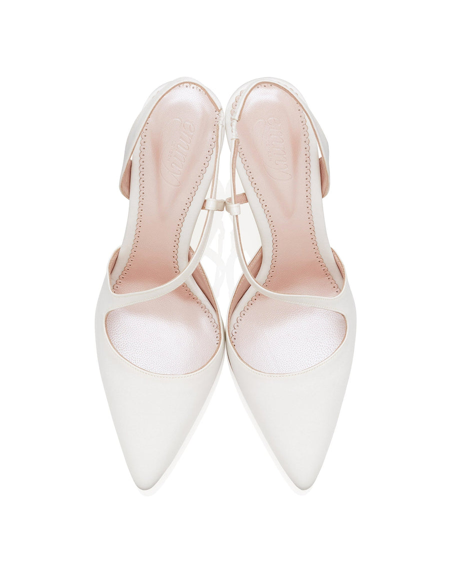 White pointed-toe heels with a slingback design, featuring a delicate strap across the ankle. The shoes are displayed from a top-down angle against a plain white background, highlighting the smooth leather material and elegant silhouette. image