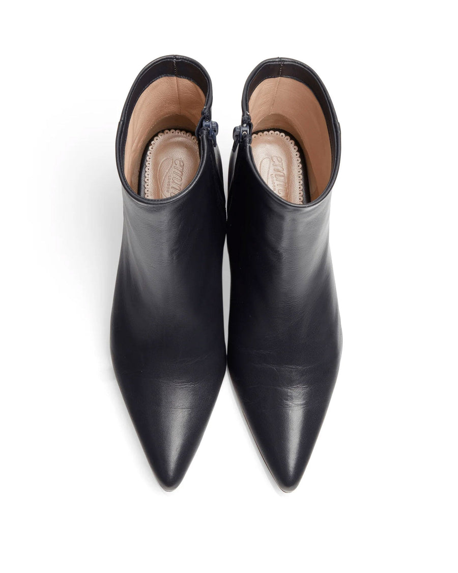 Navy leather ankle boots with a pointed toe design, featuring a side zipper for easy wear. The image is taken from a top-down angle, showcasing the smooth finish of the leather. The background is plain white, emphasizing the sleek silhouette of the boots. image