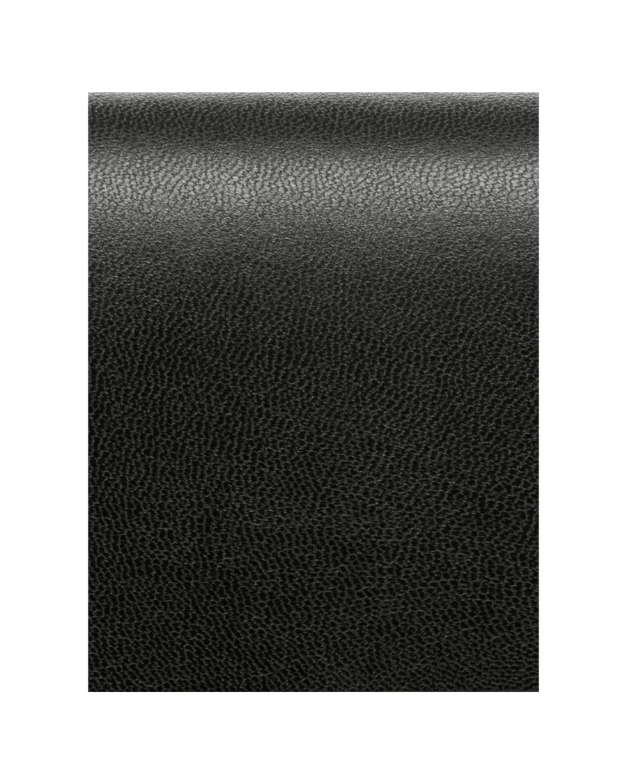 The image shows a close-up of a textured black material, likely leather. There are no shoes or heels visible in the image. image