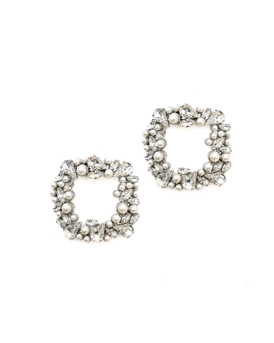 The image features a pair of statement earrings designed in a square shape, adorned with an array of sparkling crystals and pearls. The earrings are set against a clean, white background, highlighting their intricate detailing. The angle of the image showcases the earrings from the front, allowing for a clear view of their embellishments. image