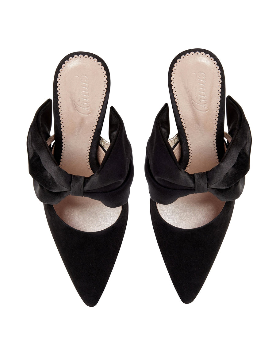 Black suede heels featuring a pointed toe and a large satin bow on the front. The shoes are displayed from a top-down angle against a white background, showcasing their elegant design. image