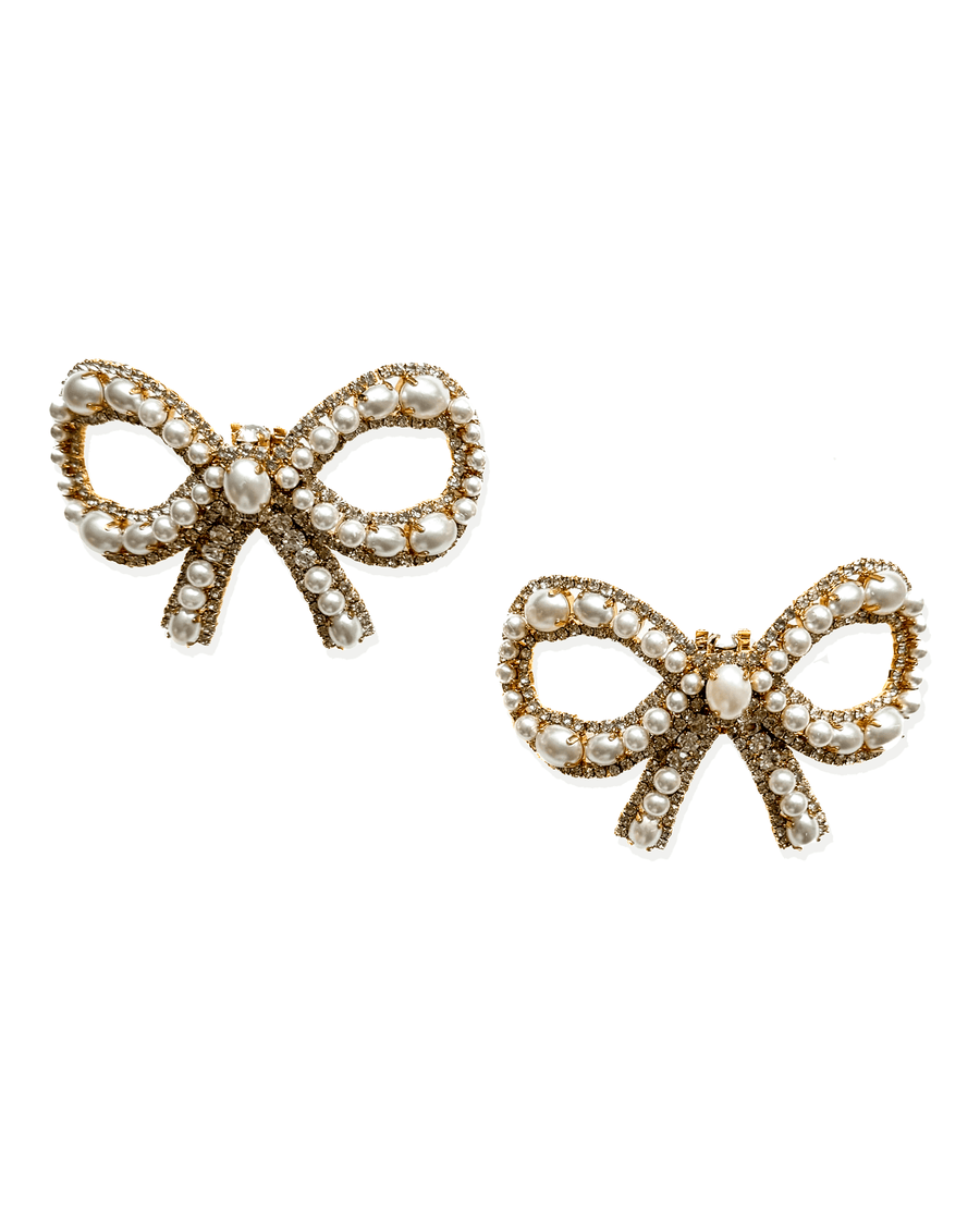 Gold-tone bow-shaped earrings adorned with pearls, set against a white background. The earrings feature intricate detailing and a classic design, showcasing a luxurious aesthetic. image
