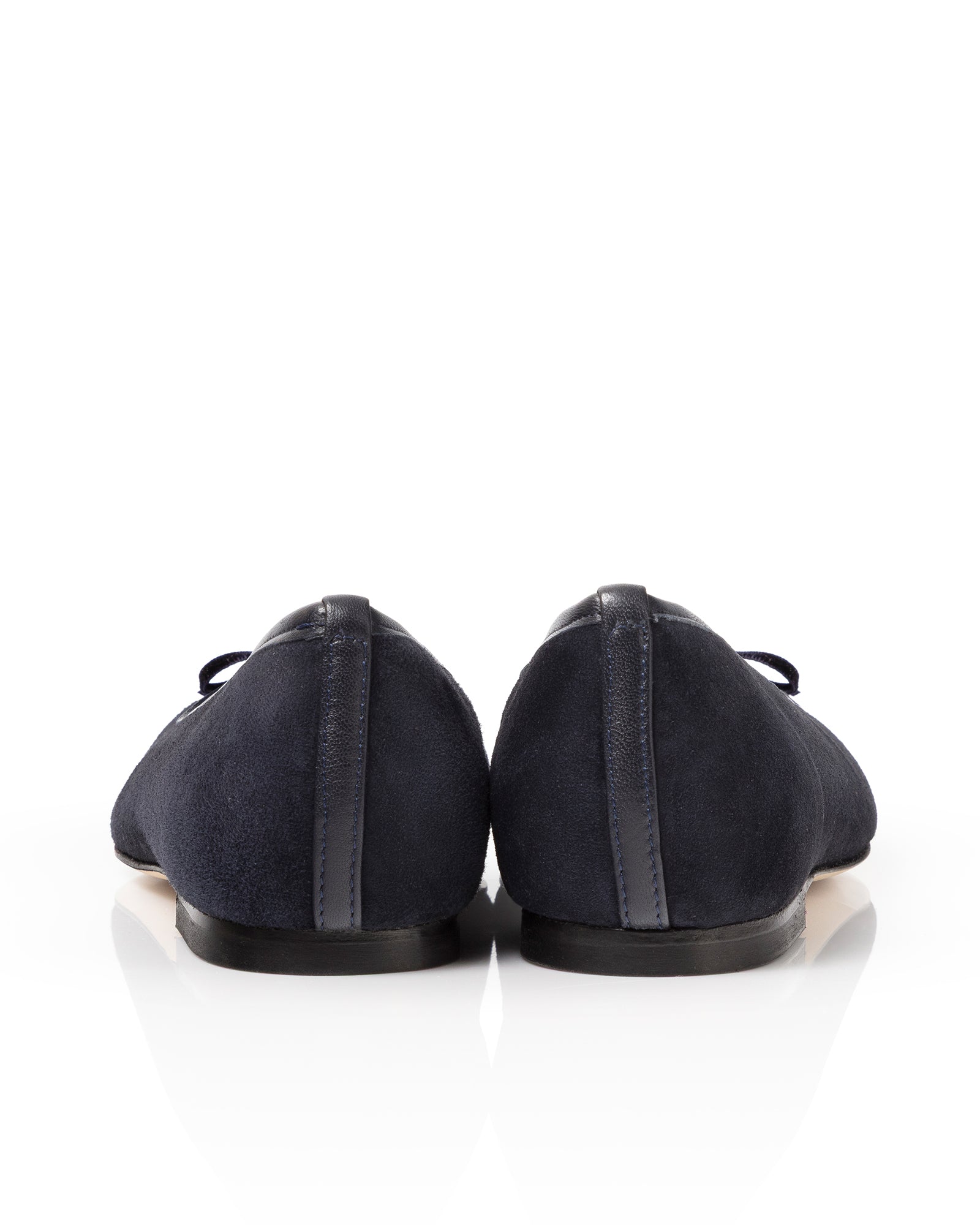 Pair of navy suede ballet flats on a white background image
