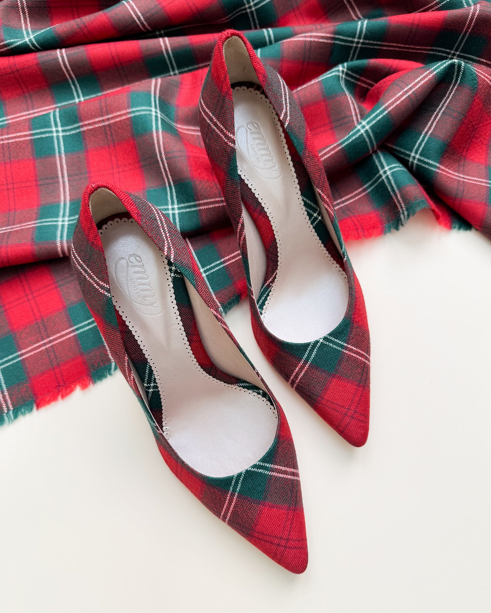 Red and green plaid shoes on a red and green plaid fabric background image