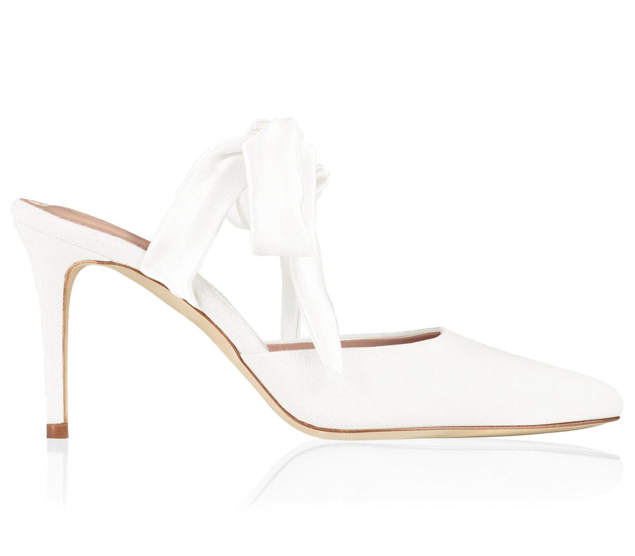 White slingback heels with a pointed toe and a delicate bow detail at the back. The heel height is approximately 4 inches. The shoes are set against a clean, white background, showcasing their elegant design. image