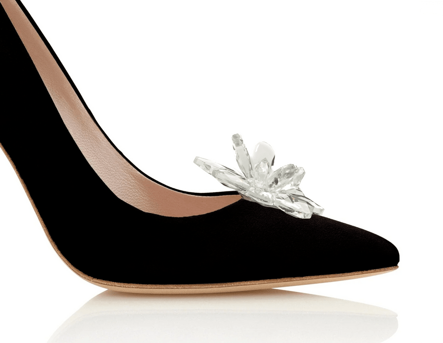 Black suede heels featuring a decorative crystal embellishment on the toe. The image is taken from a close-up angle, highlighting the shoe's elegant silhouette against a clean white background. image