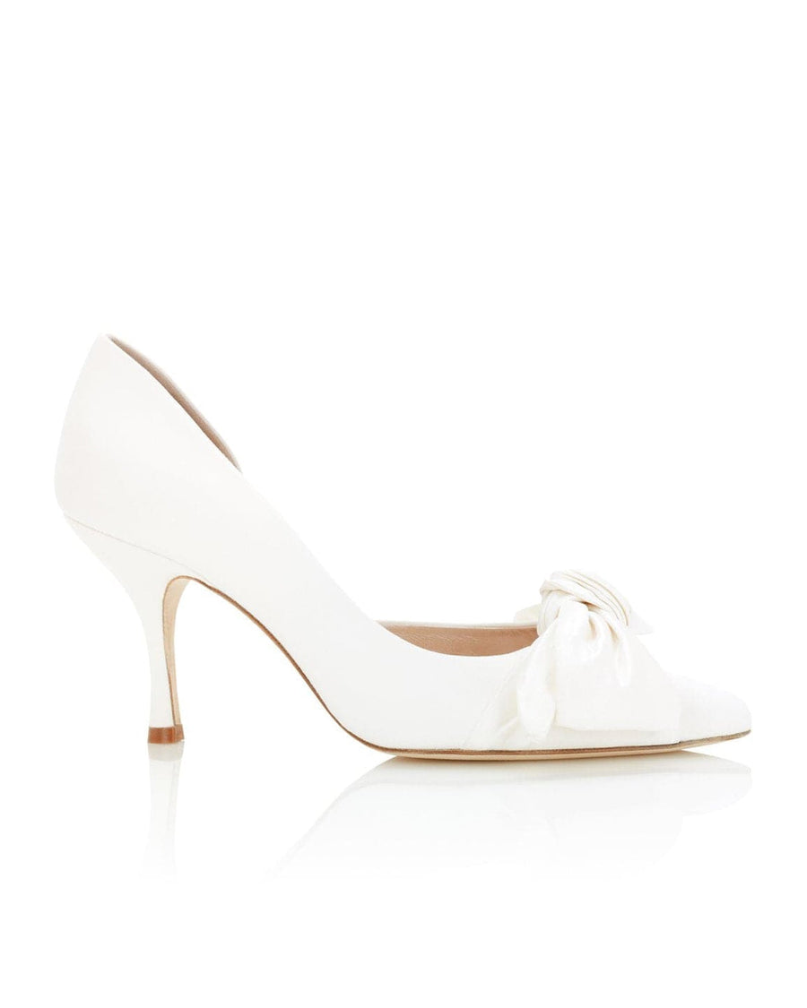 White leather heels with a pointed toe and a decorative bow detail on the front. The heel is approximately 3 inches high, and the shoe is displayed against a clean, reflective surface that highlights its elegant design. The image is taken from a side angle, showcasing the shoe's silhouette. image