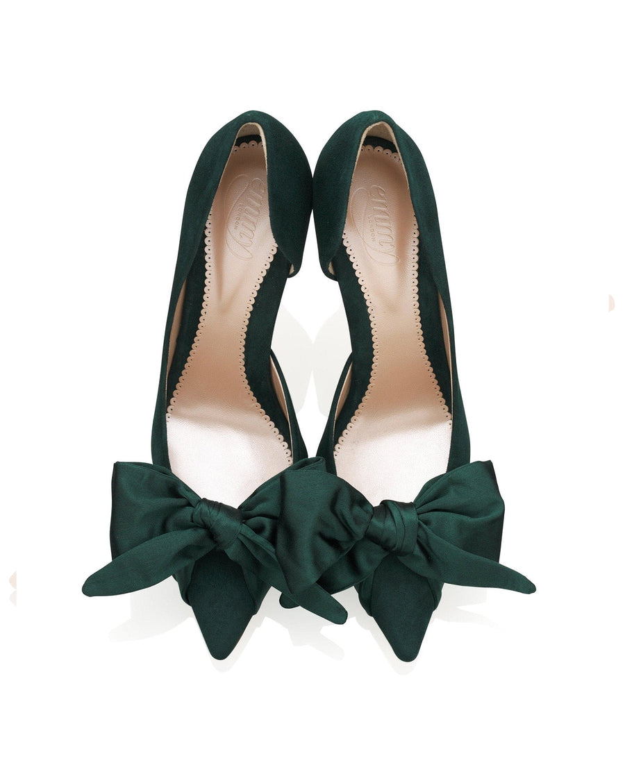 Green suede heels with a pointed toe and large bow detail at the front. The shoes are displayed from a top-down angle against a white background, showcasing their elegant design. image