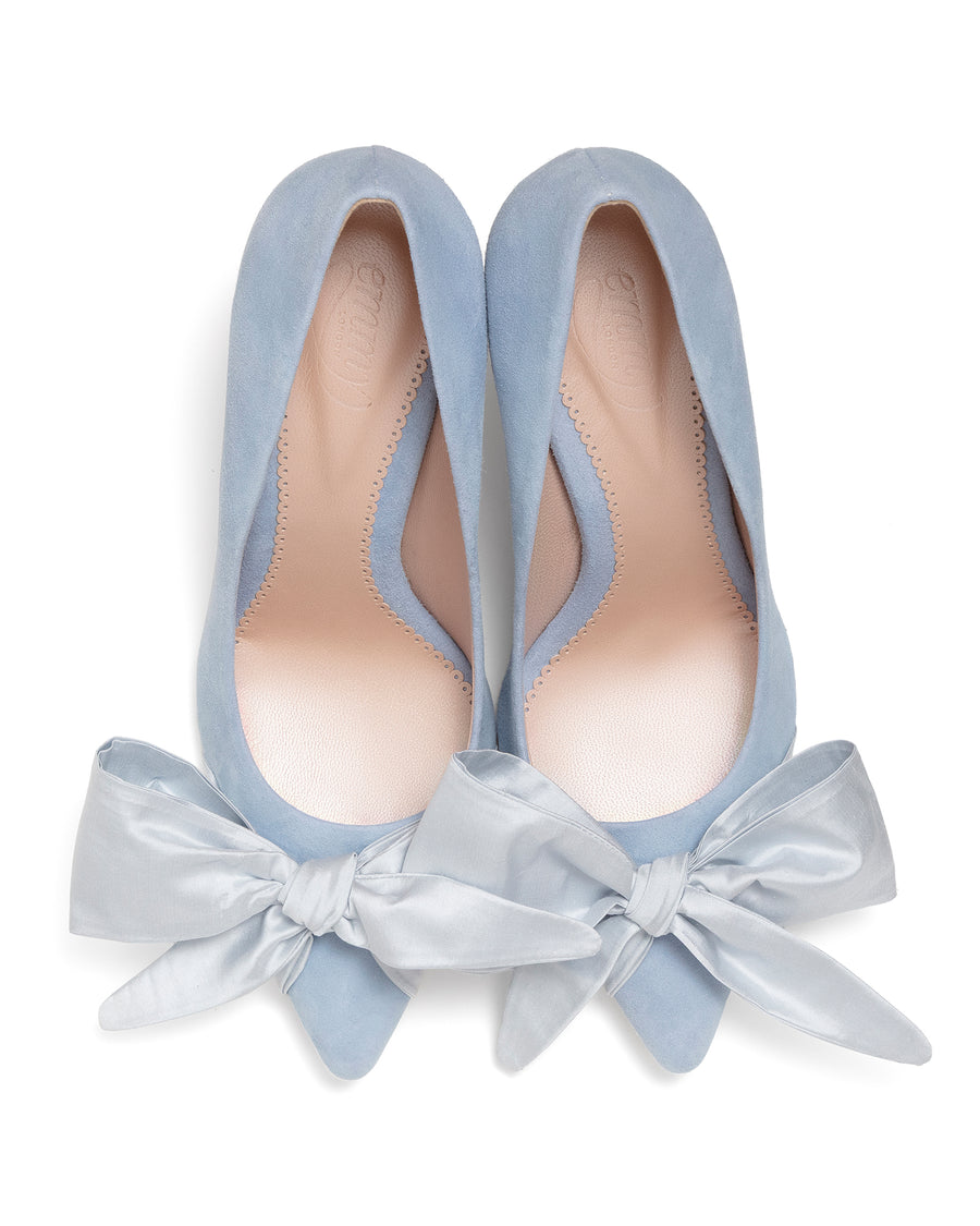 Blue suede court shoes with blue satin bow on white background image
