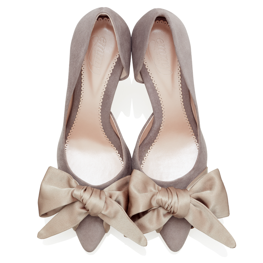 Elegant gray suede heels featuring a large satin bow at the front. The shoes are displayed from a top-down angle against a clean white background, highlighting their sleek design and soft texture. image