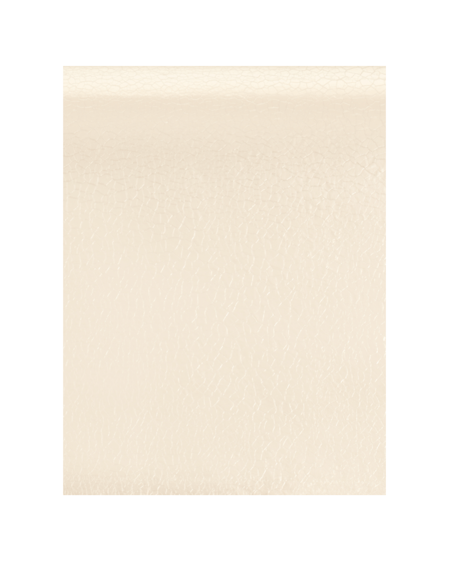 The image shows a close-up of a textured cream-colored material, likely leather. The background is plain white, emphasizing the texture of the material. There are no shoes or heels present in the image. image