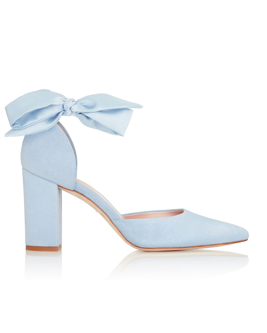 Light blue suede heels with a block heel and a bow detail at the ankle. The shoe is shown from the side against a neutral background, highlighting its pointed toe and elegant design. image