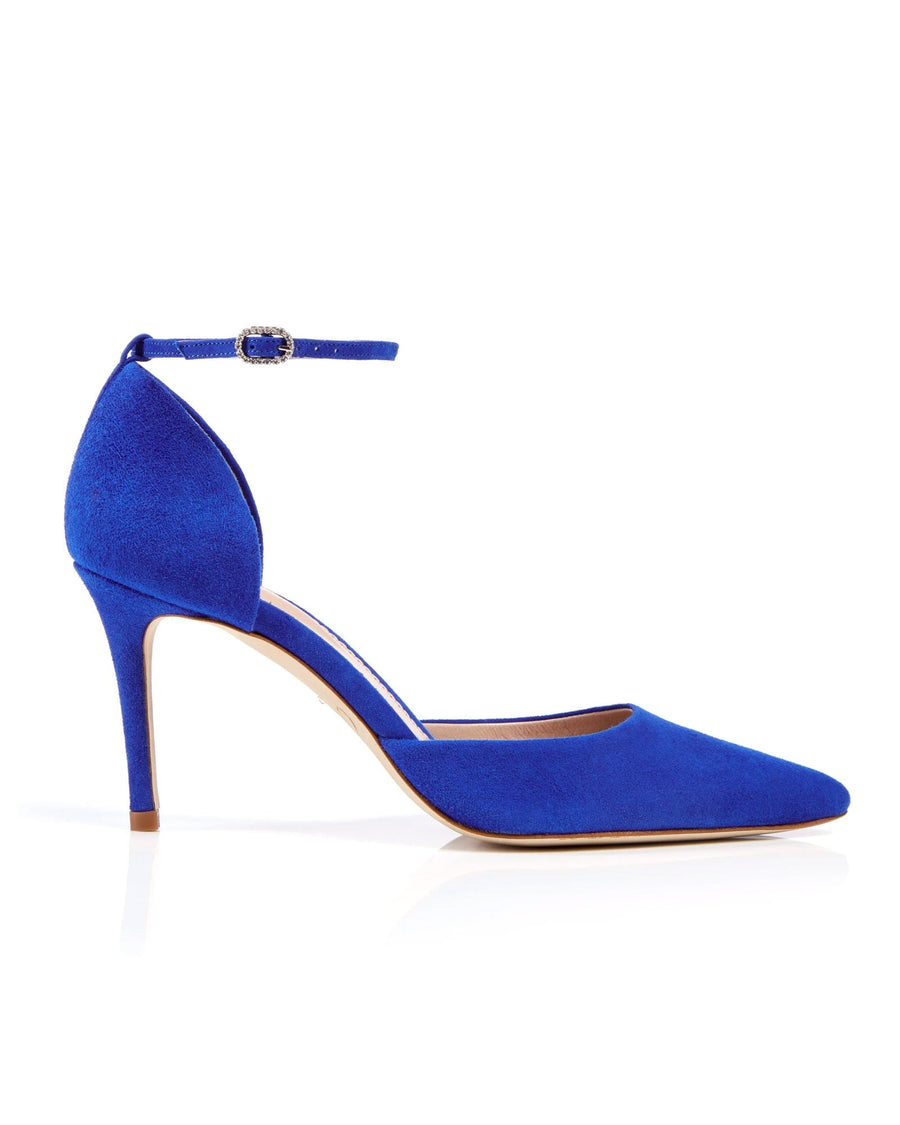 Blue suede heels with a pointed toe and an ankle strap, showcased against a white background. The shoe is positioned at a slight angle to highlight its elegant silhouette. image