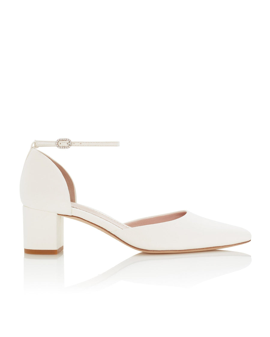 White block-heeled shoes with a pointed toe and ankle strap, set against a clean white background. The heel height is approximately 2.5 inches, and the material is likely leather. The shoes are displayed at a slight angle to showcase the design. image