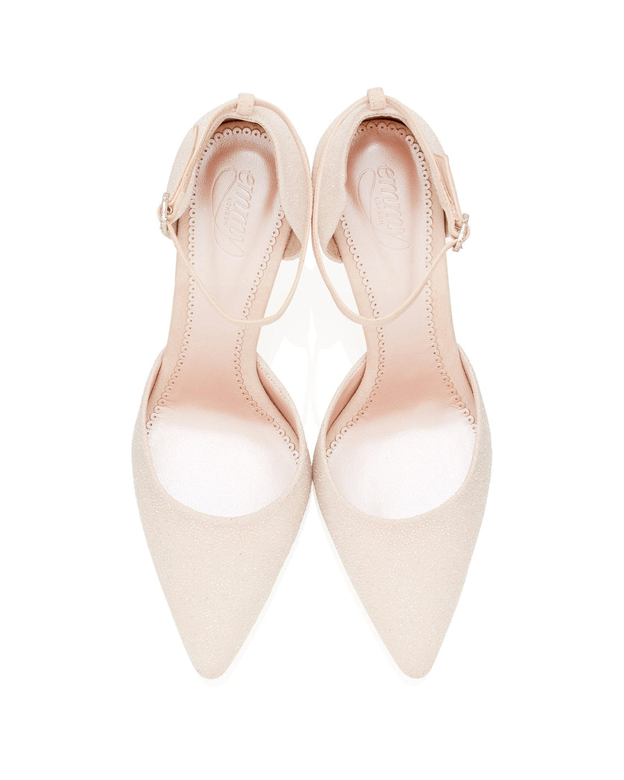 Pointed-toe heels in a soft beige color, featuring a delicate ankle strap. The shoes have a smooth finish and are set against a clean white background, showcasing their elegant design from a top-down angle. image