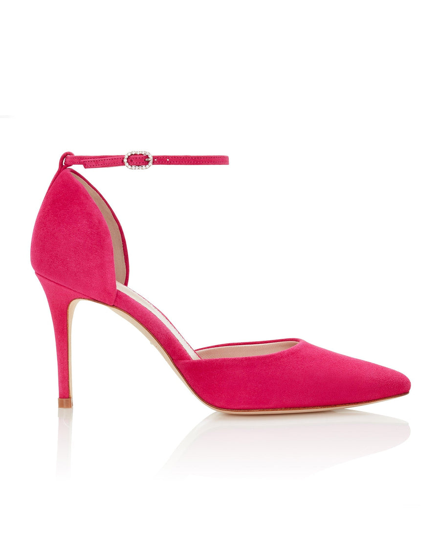 Pink suede heels with a pointed toe and an ankle strap featuring a decorative buckle. The shoes are displayed against a clean, white background, showcasing their elegant silhouette from a side angle. The heel height is approximately 4 inches. image