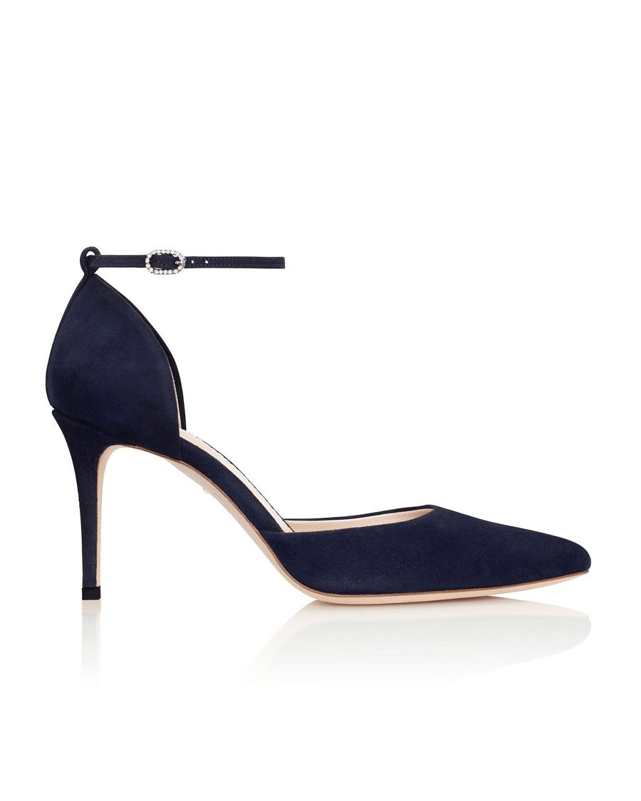 Navy suede heels with a pointed toe and an ankle strap, set against a white background. The shoe features a sleek silhouette and a stiletto heel, showcasing a modern and elegant design. image