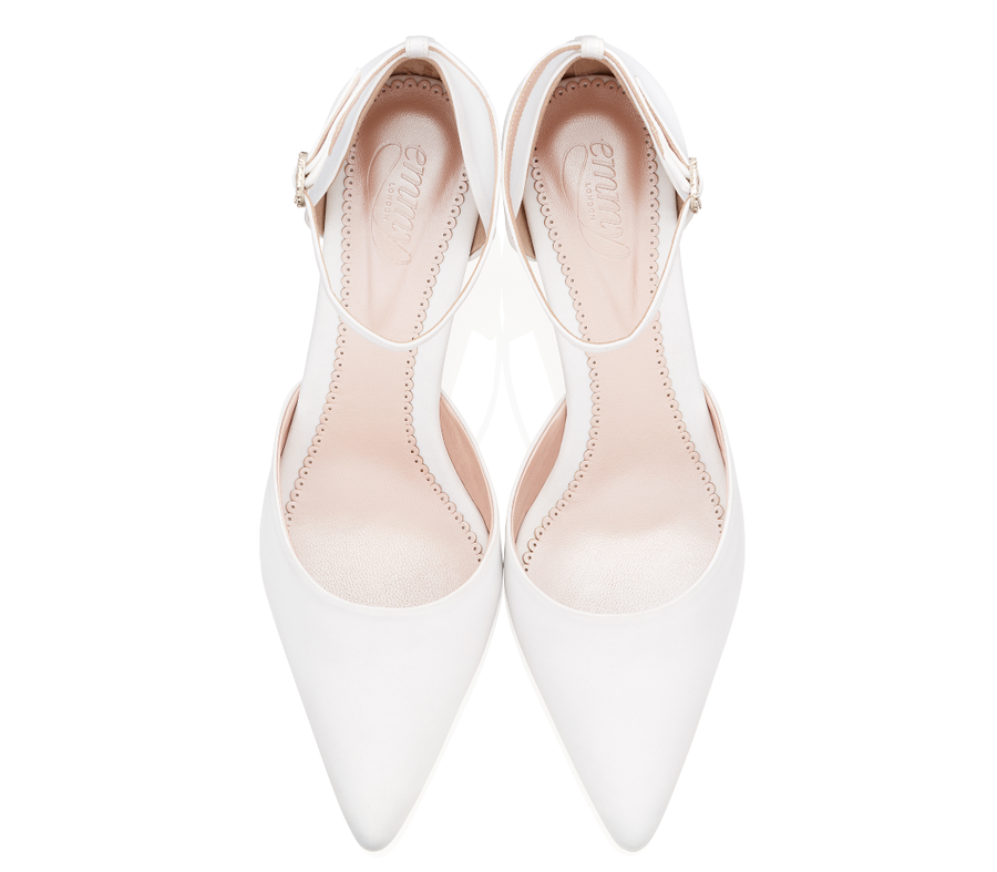 White pointed-toe heels with a sleek design, featuring a delicate ankle strap. The shoes are displayed from a top-down angle against a plain white background, highlighting their smooth finish and elegant silhouette. image