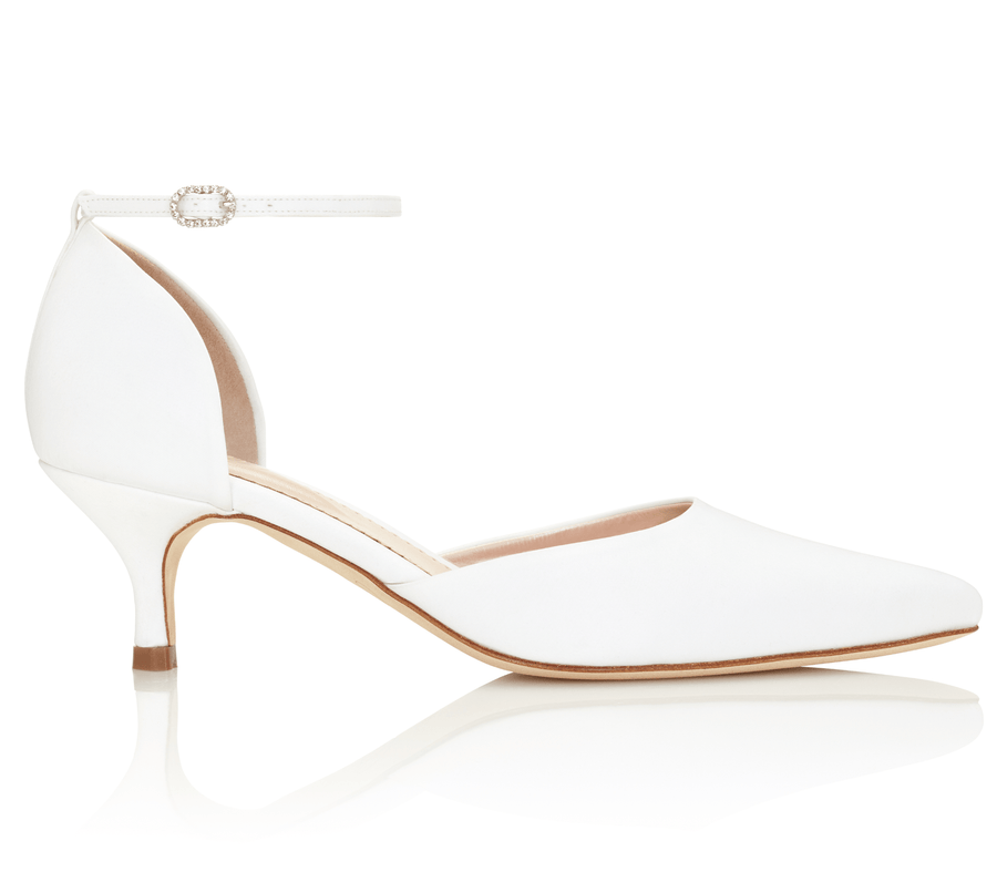 White leather heels with a pointed toe and a delicate ankle strap featuring a small embellishment. The heel height is approximately 2.5 inches. The shoe is positioned against a clean, white background, showcasing its elegant design. image