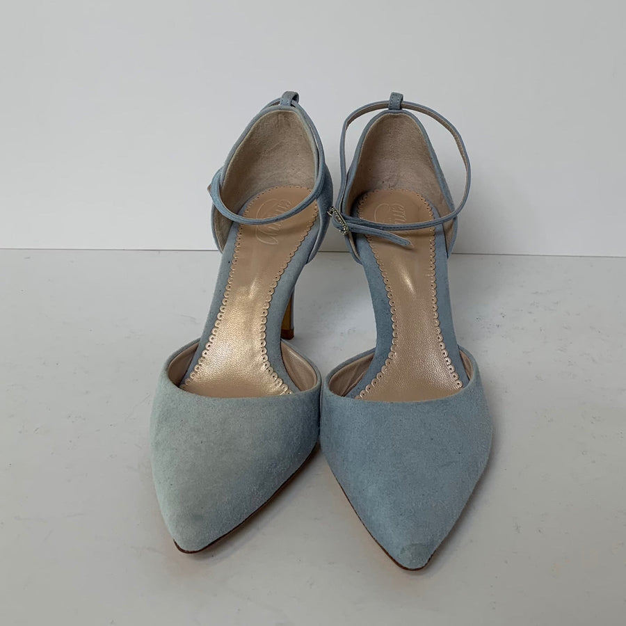 Light blue suede heels with a pointed toe and a delicate ankle strap. The shoes are displayed against a plain white background, showcasing their elegant design. The heel height is approximately 3 inches. image