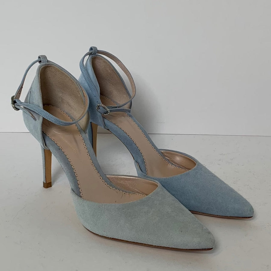 Light blue suede heels with a pointed toe and a delicate ankle strap. The shoes are displayed on a white background, showcasing their elegant design and slim stiletto heel. image