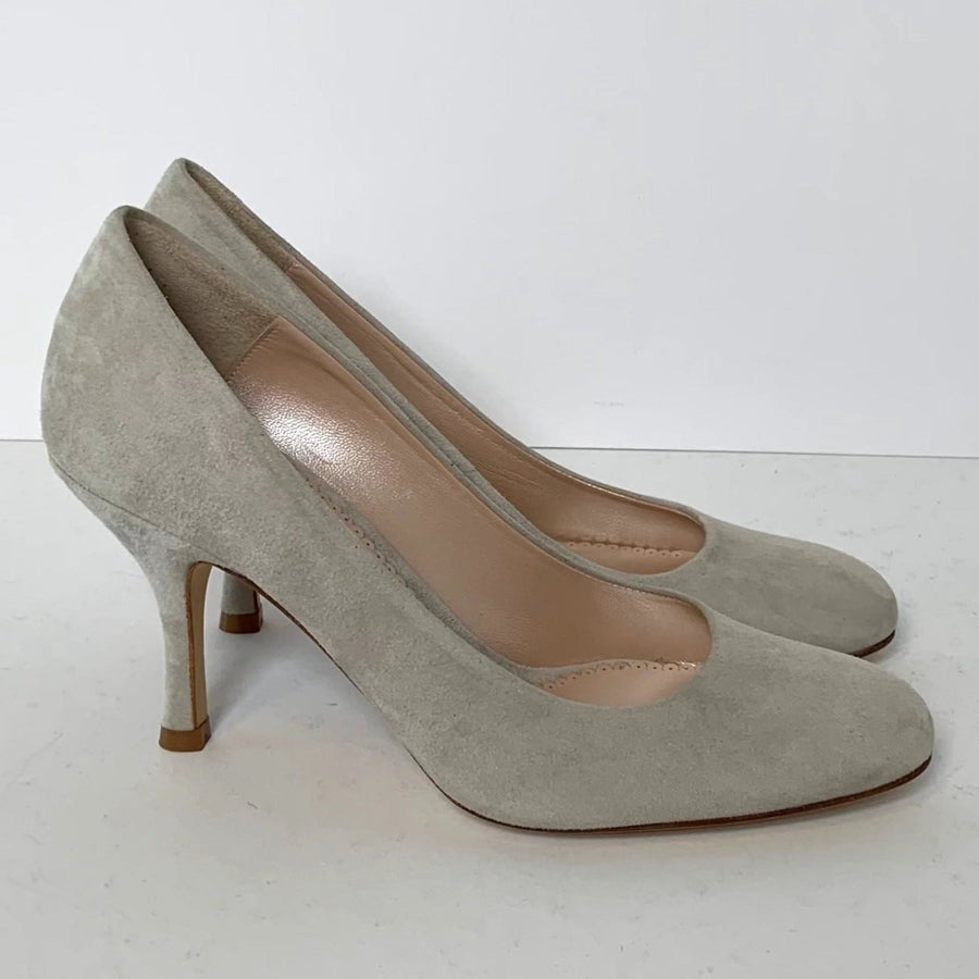 Light grey suede heels with a sleek design, featuring a rounded toe and a moderate stiletto heel. The shoes are positioned on a plain white background, showcasing their elegant silhouette. image