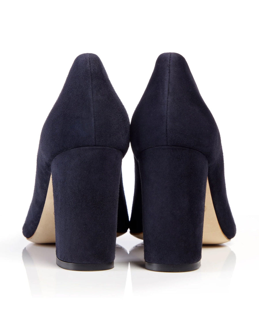 Navy suede high heels with a chunky heel, showcasing a sleek design. The image is taken from the back, highlighting the smooth texture of the material and the sturdy heel. The background is plain white, emphasizing the shoes. image