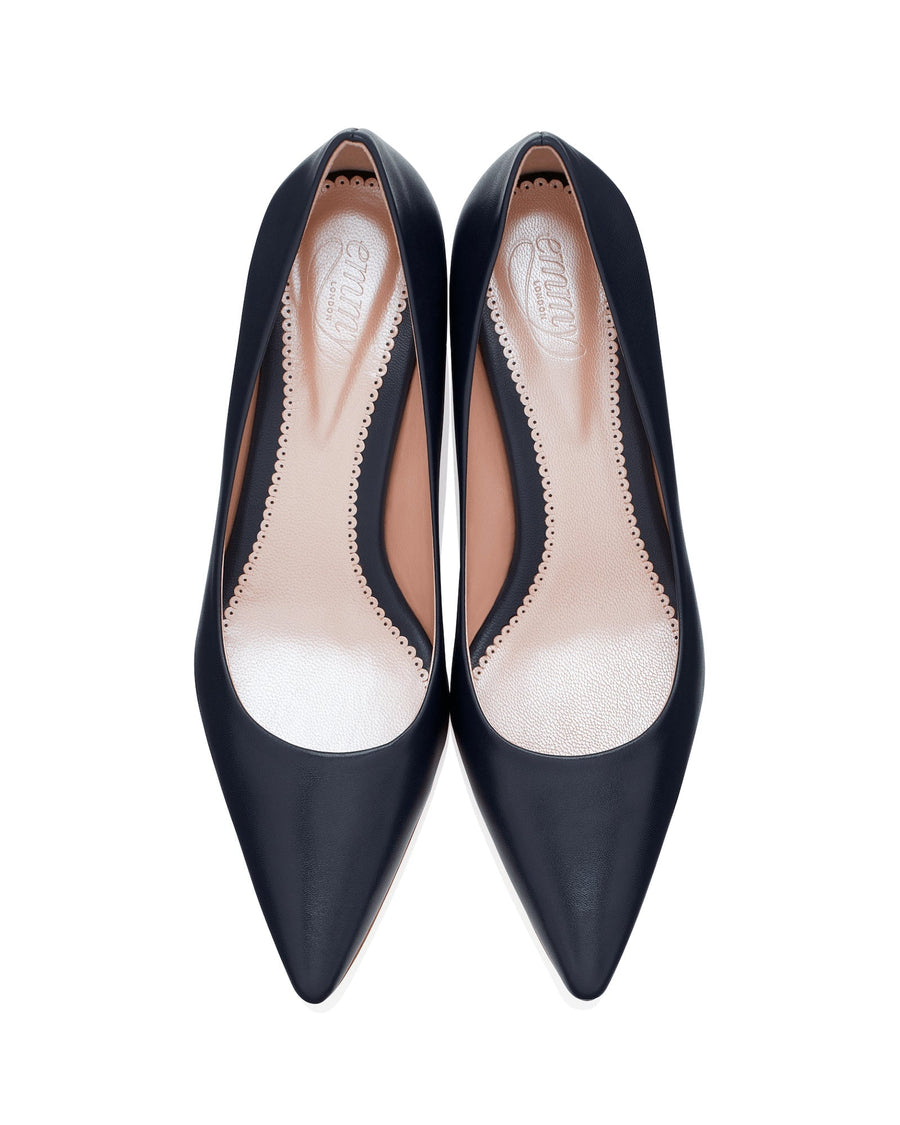 Black leather heels with a pointed toe design, featuring a sleek silhouette. The shoes are displayed from a top-down angle against a white background, highlighting their smooth finish and elegant shape. image