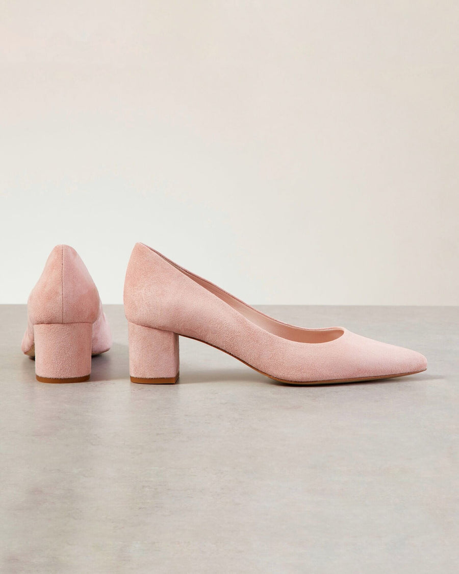 Pink suede pumps with a block heel, displayed from a side angle against a neutral background. The shoes feature a pointed toe and a comfortable heel height, suitable for everyday wear. image