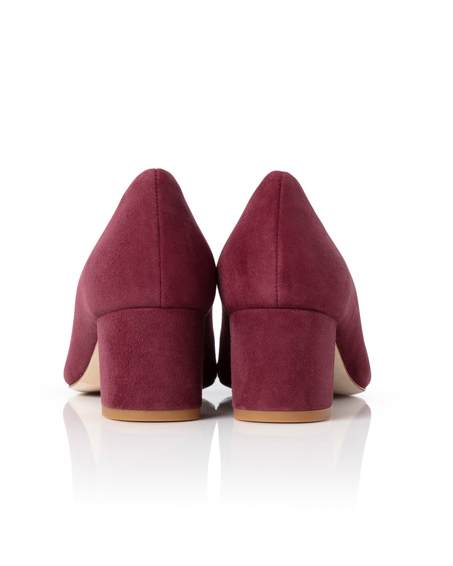 Pair of maroon low-heeled shoes on a white background image