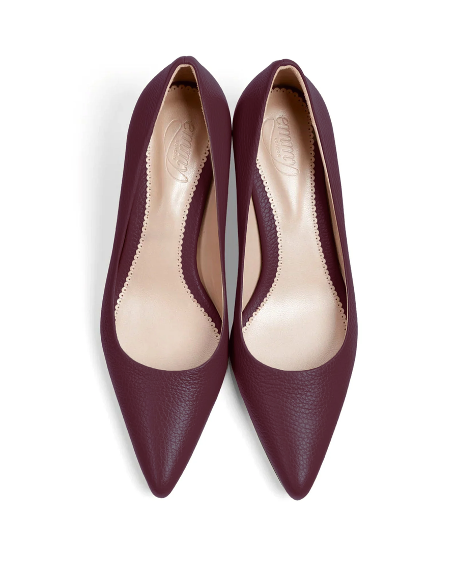 Burgundy leather heels with a pointed toe design, featuring a low-cut vamp that enhances the foot's silhouette. The shoes are displayed from a top-down angle against a white background, showcasing their smooth texture and elegant shape. image