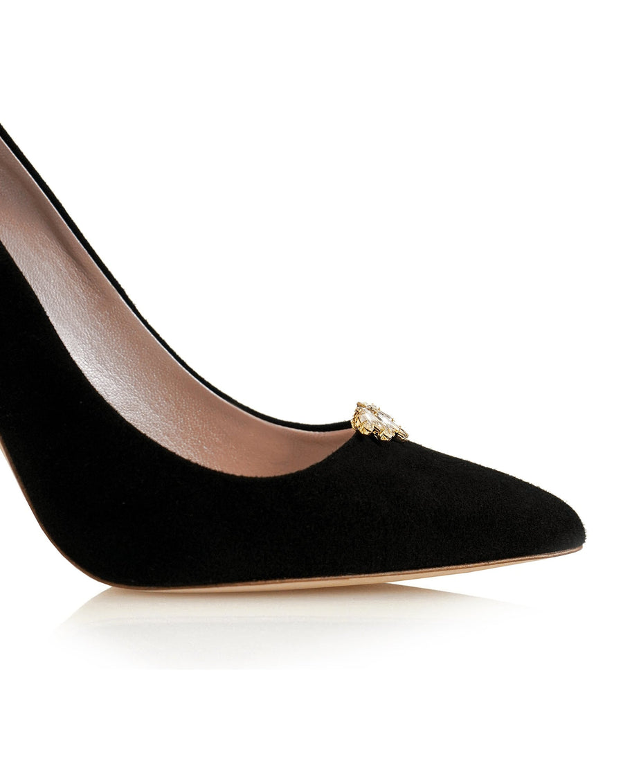 Black suede heels with a pointed toe and a decorative gold embellishment on the front. The image is taken from a close-up angle, highlighting the shoe against a white background. image
