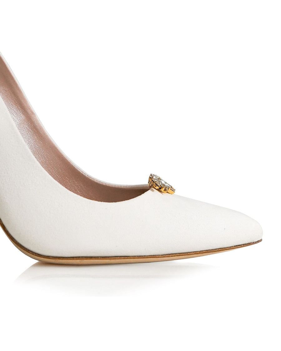 White pointed-toe heels featuring a decorative gold embellishment on the vamp. The shoes are set against a clean, white background, showcasing their sleek design. The angle highlights the sharp silhouette and elegant profile of the heel. image