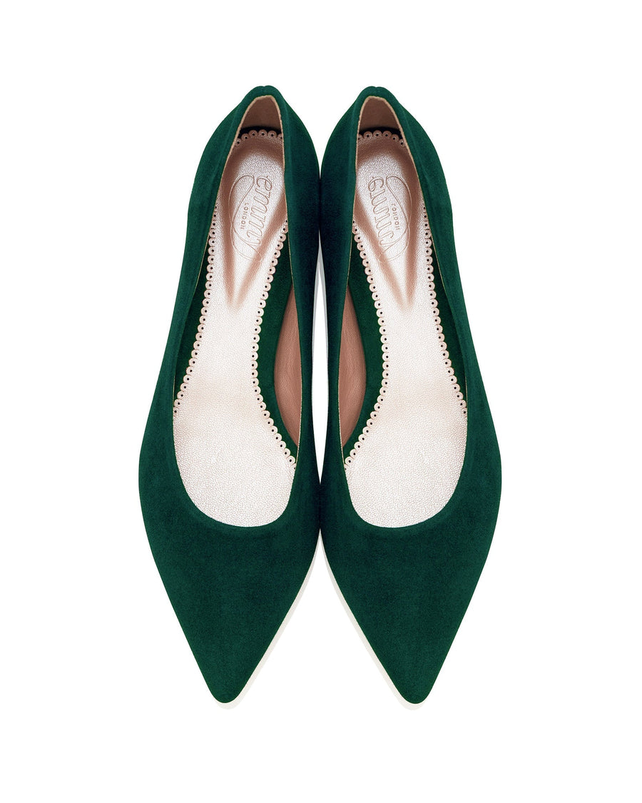 Green suede pointed-toe heels with a sleek design, featuring a smooth interior lining. The shoes are displayed from a top-down angle against a white background, highlighting their elegant shape and rich color. image