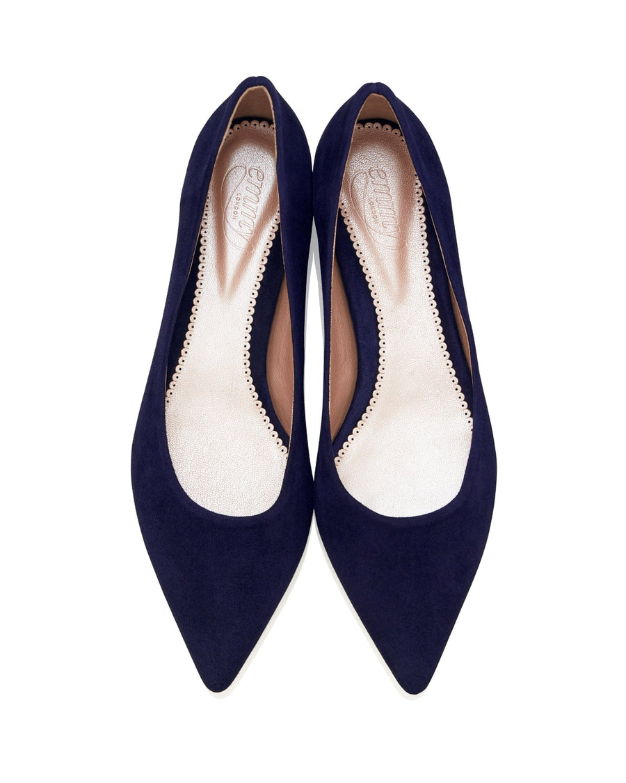 Navy suede pointed-toe heels with a sleek design, featuring a smooth interior lining. The shoes are displayed from a top-down angle against a white background, showcasing their elegant silhouette. image