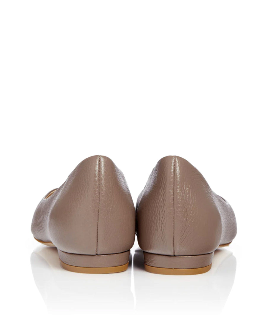 Back view of a pair of taupe flats with a smooth leather finish. The shoes feature a rounded toe and a low-profile design. The background is plain white, highlighting the shoes. image