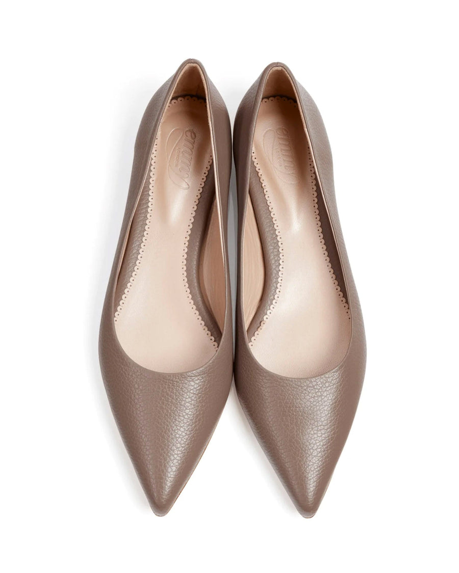 Pointed-toe flats in a soft taupe leather, showcasing a smooth texture. The shoes are displayed from a top-down angle against a clean white background, emphasizing their sleek design. image