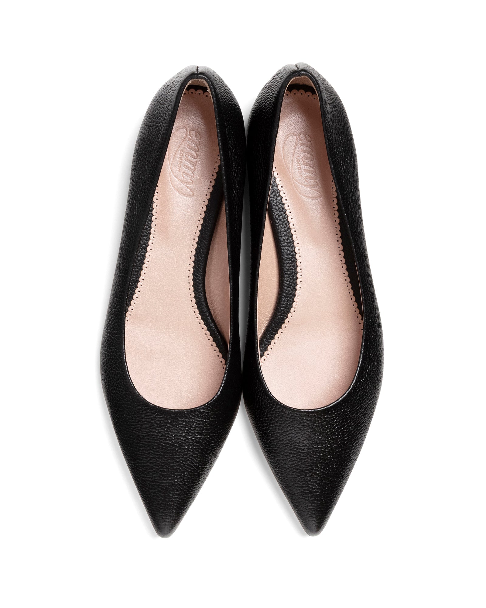 Pair of black pointed-toe shoes on a white background image