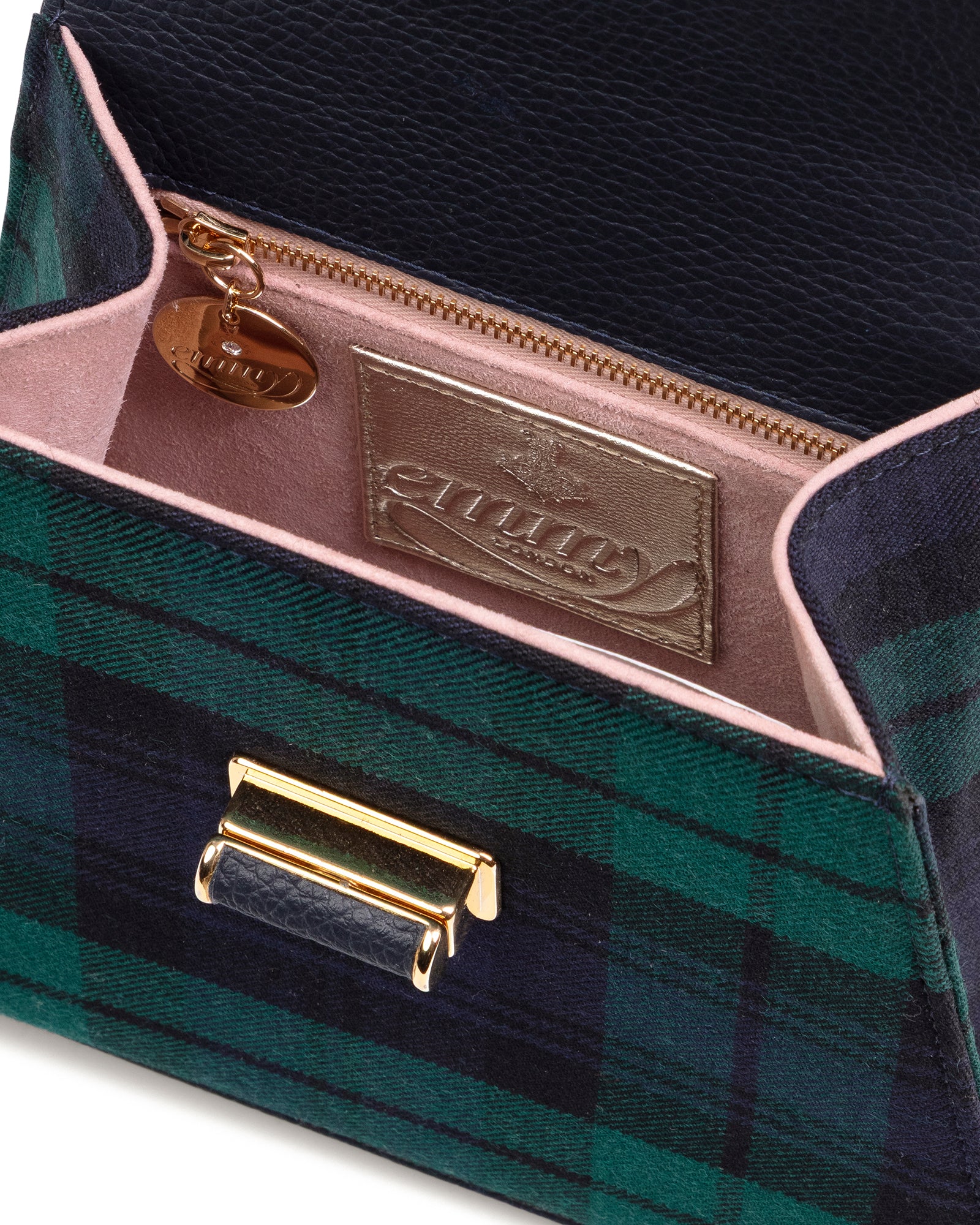 Close-up of a green plaid handbag with gold accents and a visible brand logo. image