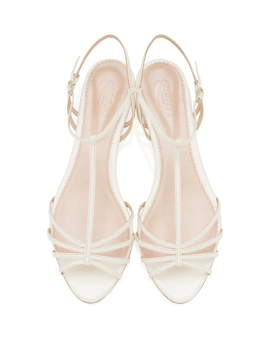 Strappy sandals featuring a delicate design with thin straps in a light cream color. The shoes have a flat heel and are displayed from a top-down angle against a white background. image