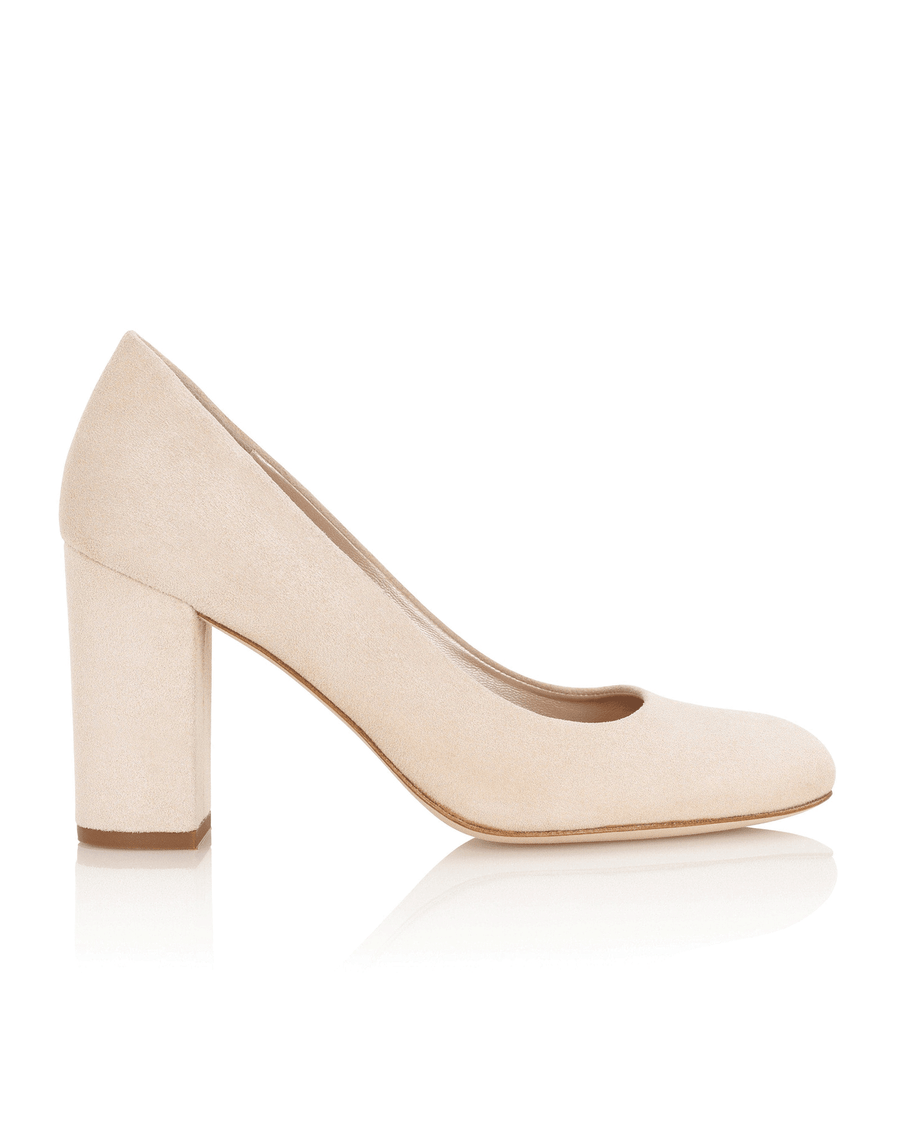 Beige suede block heel pumps with a rounded toe, featuring a sturdy block heel for added stability. The shoes are displayed against a clean white background, showcasing their elegant design from a side angle. image