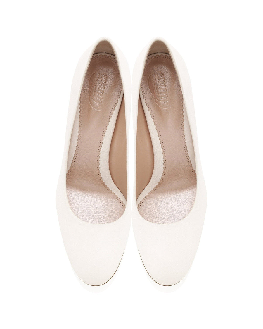 Pair of white shoes with brown accents on a white background image