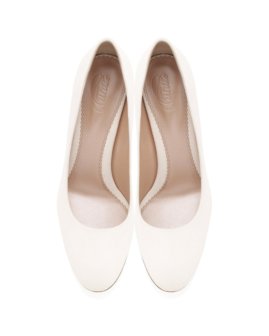 Pair of white high-heeled shoes on a white background image