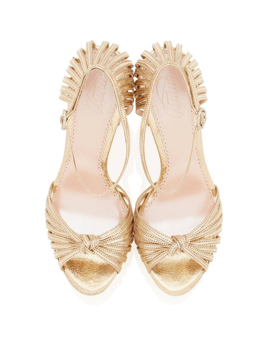 Gold heels with a decorative fringe design, featuring an open toe and ankle strap. The shoes are displayed from a top-down angle against a white background, showcasing their intricate detailing and elegant style. image
