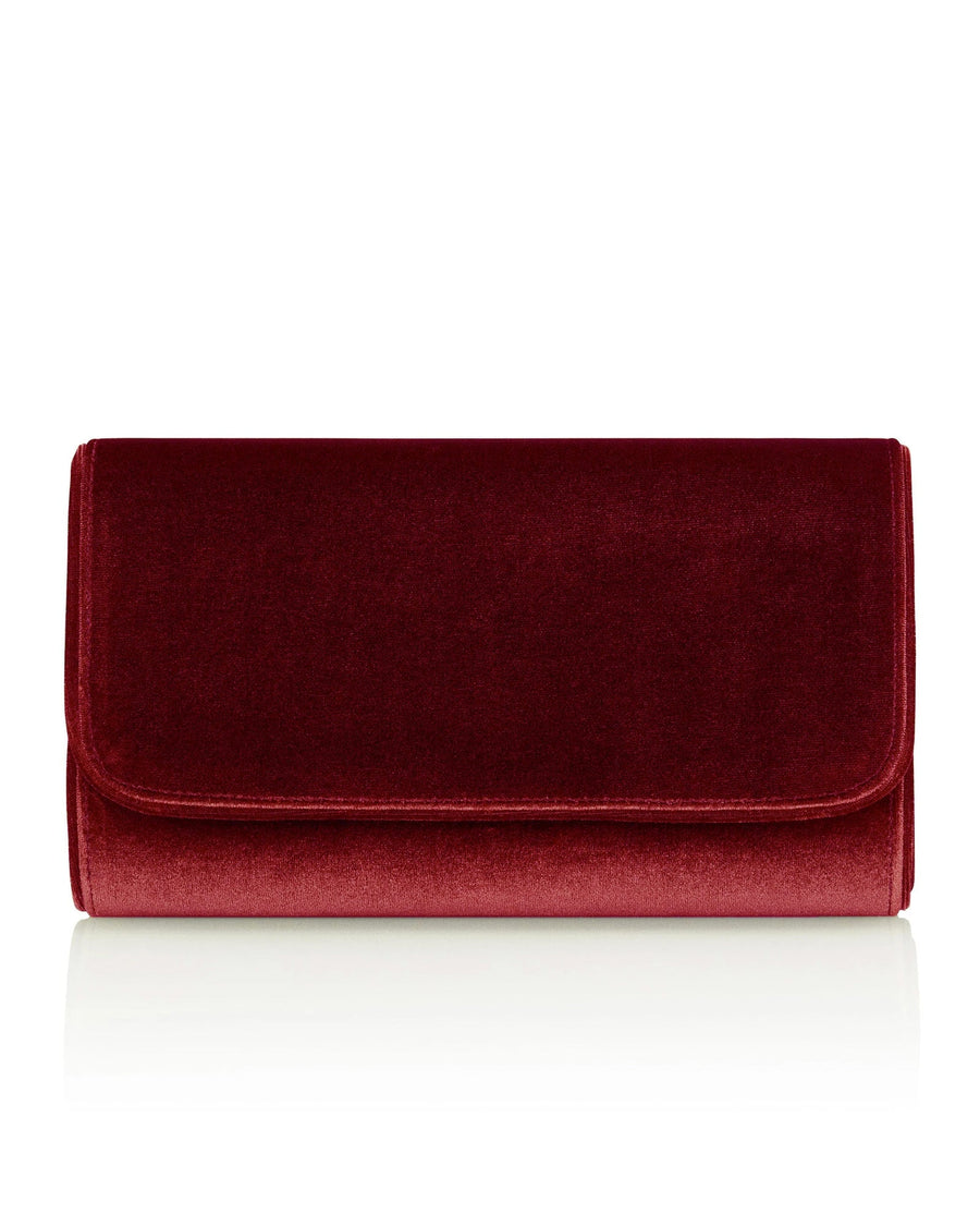 Red velvet clutch bag with a sleek, rectangular design. The bag features a flap closure and is set against a clean, white background, highlighting its rich color and texture. image