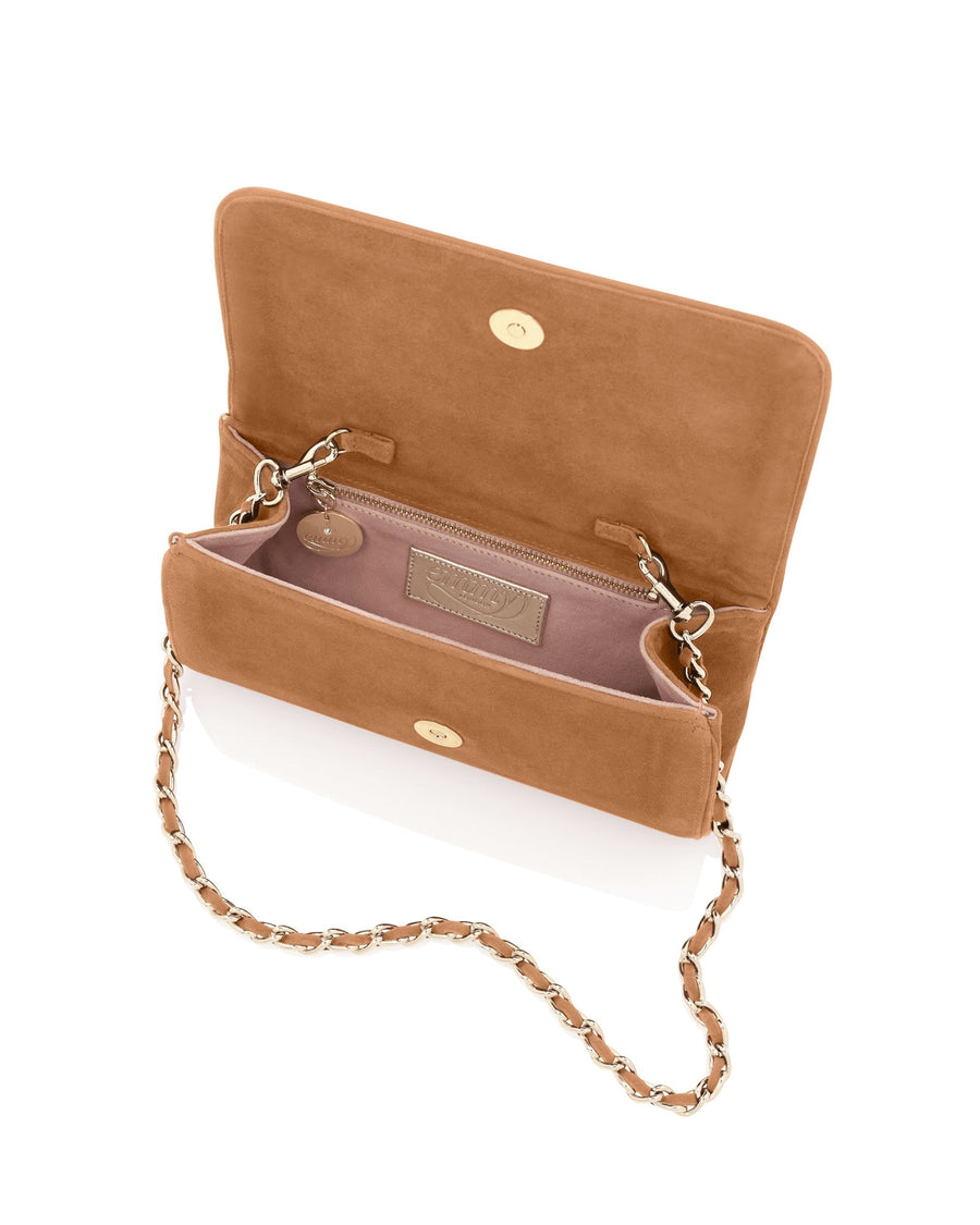 Tan suede handbag with a chain strap, featuring a spacious interior and a sleek design. The bag is shown from an overhead angle, highlighting its soft texture and elegant closure. The background is a clean, neutral surface that emphasizes the bag's color and style. image
